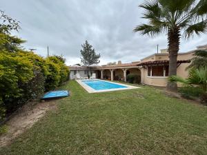 a house with a swimming pool in the yard at Cabañas Cerros Azules en La Rioja Alojamiento Temporario in La Rioja