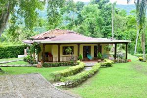a small house in the middle of a yard at Finca Milandia in Villeta