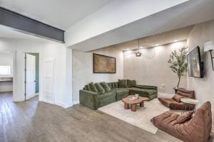 a living room with a green couch and a table at CIELO - Modern Vegas Pool Oasis, Spa, Pickleball in Las Vegas