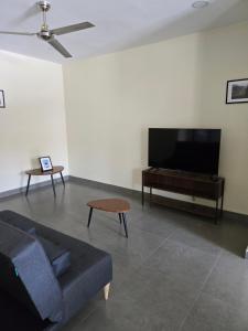 a living room with a couch and a flat screen tv at Departamento Huatulco 1 Torre Bel in Santa Cruz Huatulco