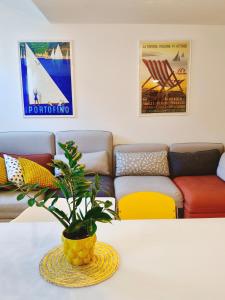 a living room with a table with a plant on it at Old Town Apartment with Terrace - Live Love Lake in Peschiera del Garda