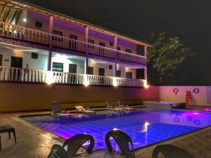a hotel with a swimming pool at night at Sea Natural in San Gil