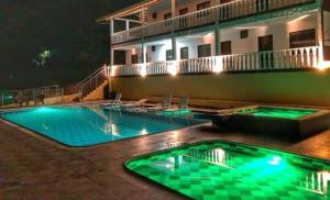 a swimming pool in front of a building at night at Sea Natural in San Gil