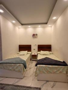 a room with two beds in a room at فندق العجمي 100 in 6th Of October