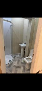 a bathroom with a shower and a toilet and a sink at The Coach House in Bradford