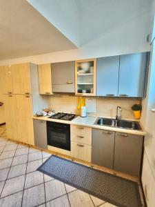 a kitchen with a sink and a stove at Old Town Apartment with Terrace - Live Love Lake in Peschiera del Garda