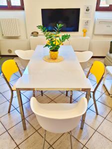 a white table with chairs and a plant on it at Old Town Apartment with Terrace - Live Love Lake in Peschiera del Garda +56 photos