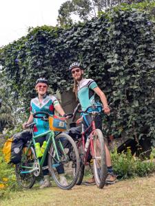 a man and a woman standing next to their bikes at Nest & Nook Ella in Ella