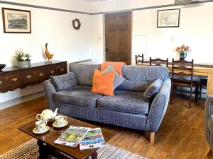 a living room with a couch and a table at Jemima's Cottage in Bassenthwaite