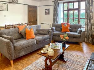 a living room with two couches and a coffee table at Jemima's Cottage in Bassenthwaite +18 photos