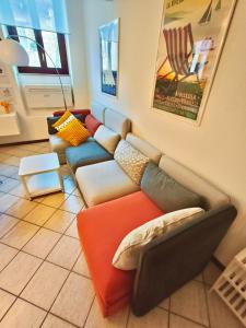 a living room with a couch with pillows on it at Old Town Apartment with Terrace - Live Love Lake in Peschiera del Garda