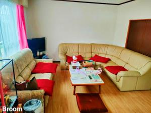 a living room with a couch and a coffee table at 别墅之家オーナーChangeAorB in Kami-furano