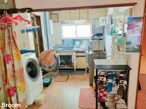 a hospital room with a washing machine and a sink at 别墅之家オーナーChangeAorB in Kami-furano