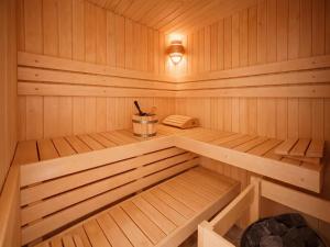 a small wooden sauna with a phone in it at Chalet in Manhay for 9 Person in Manhay