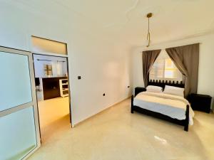 a bedroom with a bed and a large mirror at spacieuse vacation appartements in Essaouira