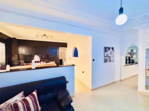 a living room with a couch and a kitchen at spacieuse vacation appartements in Essaouira