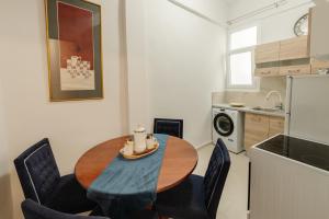 a kitchen with a wooden table and chairs in a kitchen at Venetian Balcony , Old Town Corfu in Corfu