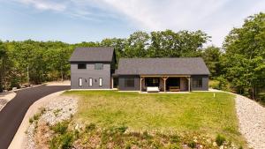 a house on a hill with a road at Villa Acadia with Mountain Views in Bar Harbor