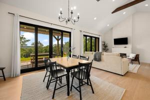 a dining room and living room with a table and chairs at Villa Acadia with Mountain Views in Bar Harbor
