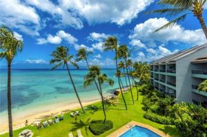 a view of the beach from the balcony of a resort at Oceanfront with Private Beach! Hale Mahina Beach Resort A206 in Lahaina