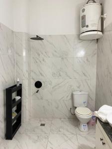 a white bathroom with a toilet and a sink at Marías in Resistencia