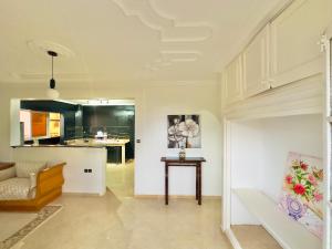 a living room with a table and a kitchen at spacieuse vacation appartements in Essaouira