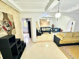 a living room with a couch and a table at spacieuse vacation appartements in Essaouira +16 photos