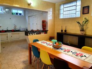a kitchen with a wooden table and chairs at Casa Antunes in Diamantina