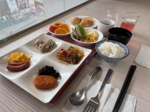a table with plates of food and bowls of rice at Hotel Premium Green Plus in Sendai +38 photos