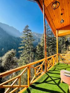 a view from the balcony of a tree house at Hideaway Tree House in Jibhi