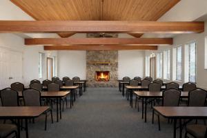 a room with tables and chairs and a fireplace at The Parkman Great Smoky Mountains - Cades Cove in Townsend +36 photos