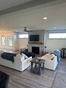 a living room with two couches and a table at 4-bedroom Lake house in Twin Creeks Winchester TN with Lakeview's, hot tub, pool in Winchester