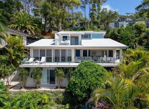 an image of a house with palm trees at Acqua Vista in Terrigal