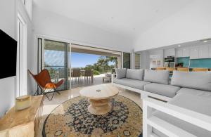 a living room with a couch and a table at Acqua Vista in Terrigal