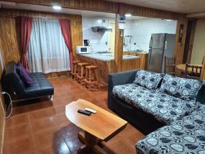 a living room with a couch and a table at Casa Cardenal in Castro