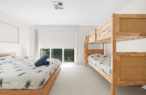 a bedroom with two bunk beds and a ladder at Acqua Vista in Terrigal +42 photos