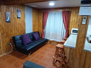 a living room with a couch and a window at Casa Cardenal in Castro