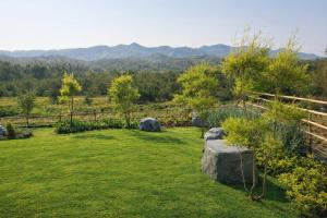 a garden with a view of the mountains at Solitude Villas in Ban Chang Talut +14 photos