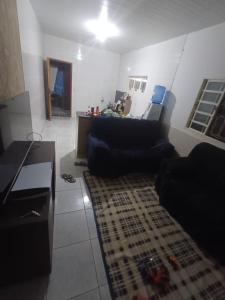 a living room with a couch and a rug at Casa moto gp in Goiânia