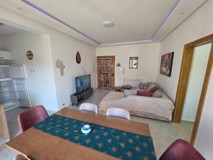 a living room with a couch and a table at Primavera Marmara Hamam sousse in Hammam Sousse