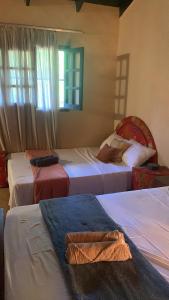 a bedroom with three beds with towels on them at Quinta Arce - Refugio Natural in Trinidad