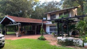 a house with a pavilion in front of it at Quinta Arce - Refugio Natural in Trinidad