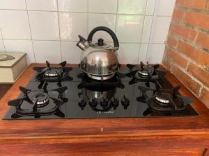 a tea kettle sitting on top of a stove at Quinta Arce - Refugio Natural in Trinidad +25 photos