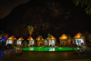 a resort with a swimming pool at night at Trang An River View Ecolodge in Ninh Binh +23 photos
