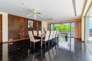 a dining room with a table and chairs at V302 Exclusive Seaview 7BR Infinity Pool Villa in Por Bay