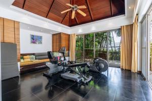 a living room with a gym with a treadmill at V302 Exclusive Seaview 7BR Infinity Pool Villa in Por Bay