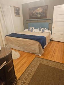 a bedroom with a bed with a blue head board at Waterfront the Alcove in Duluth