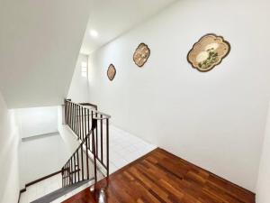 a staircase in a house with white walls and wooden floors at S Hostel sukhumvit48 Near Phrakanong BTS 2001 in Bangkok