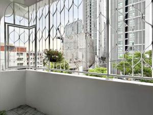 a balcony with a view of a city at S Hostel sukhumvit48 Near Phrakanong BTS 2001 in Bangkok