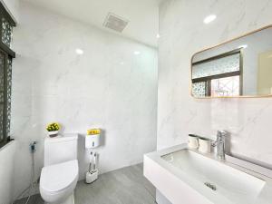 a white bathroom with a toilet and a sink at S Hostel sukhumvit48 Near Phrakanong BTS 2001 in Bangkok +18 photos